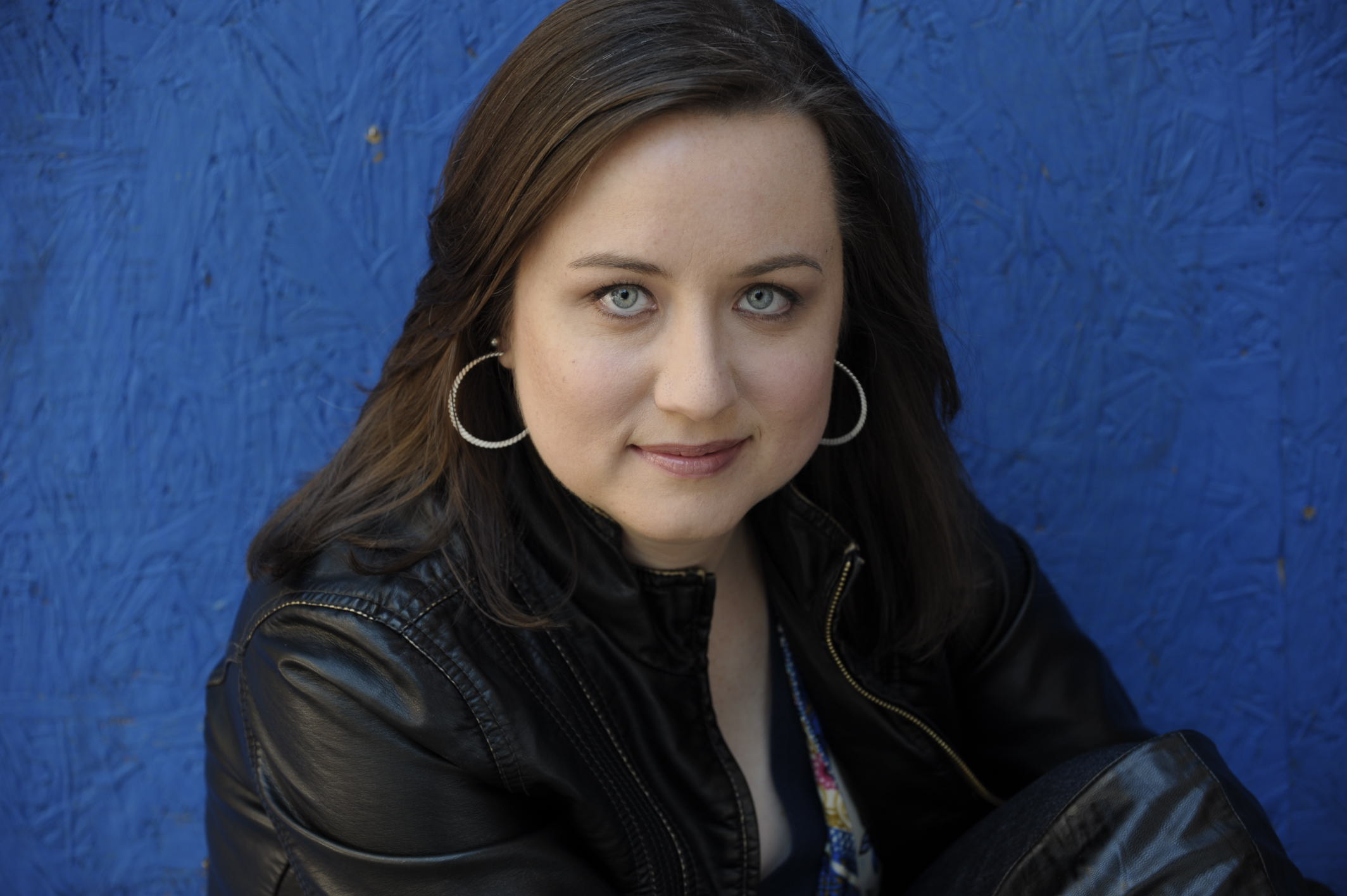 A woman with long hair wearing black jacket.